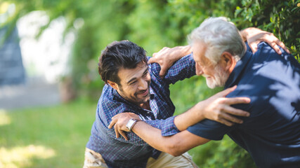 Naklejka na ściany i meble senior father and hipster adult son are happy love and relaxing together at nature outdoor park, mature family of elderly caucasian beard man playing fun with family in retirement leisure time