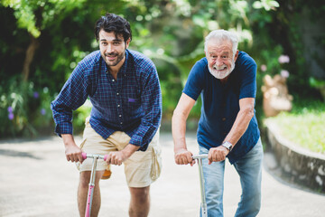 senior father and hipster adult son are happy love and relaxing together at nature outdoor park,...