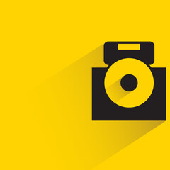 digital camera with shadow on yellow background