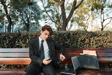 Fototapeta premium young man in casual suit working out in a park outdoors
