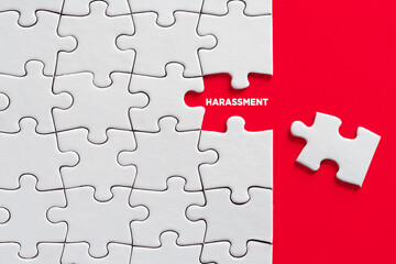 To reveal or expose harassment concept. The word harassment written on missing puzzle piece