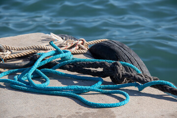 Boat ropes on  mooring bollard,  yachts marina pier