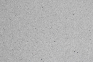 Grey background. Texture of gray recycled cardboard close-up.