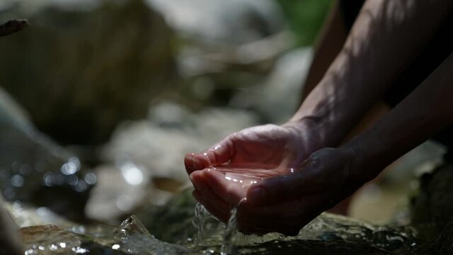 close-up of scooping up clean mountain water in your hands