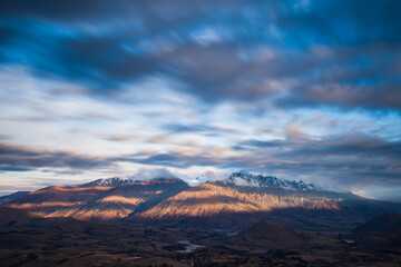 Long exposure of cloud passing over the top of the Remarkables, Wakatipu Basin, Queenstown, New Zealand