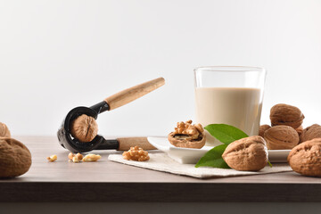 Glass full of vegetable milk of nuts with fruits around