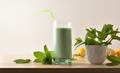 Milk with mint on wooden bench isolated white