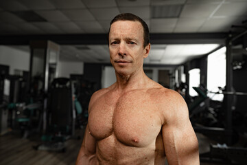 Fototapeta na wymiar Portrait of a senior muscular man in a gym