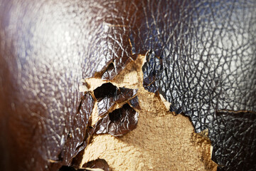 Shabby and worn brown faux leather texture background with cracks and damages, repairman...