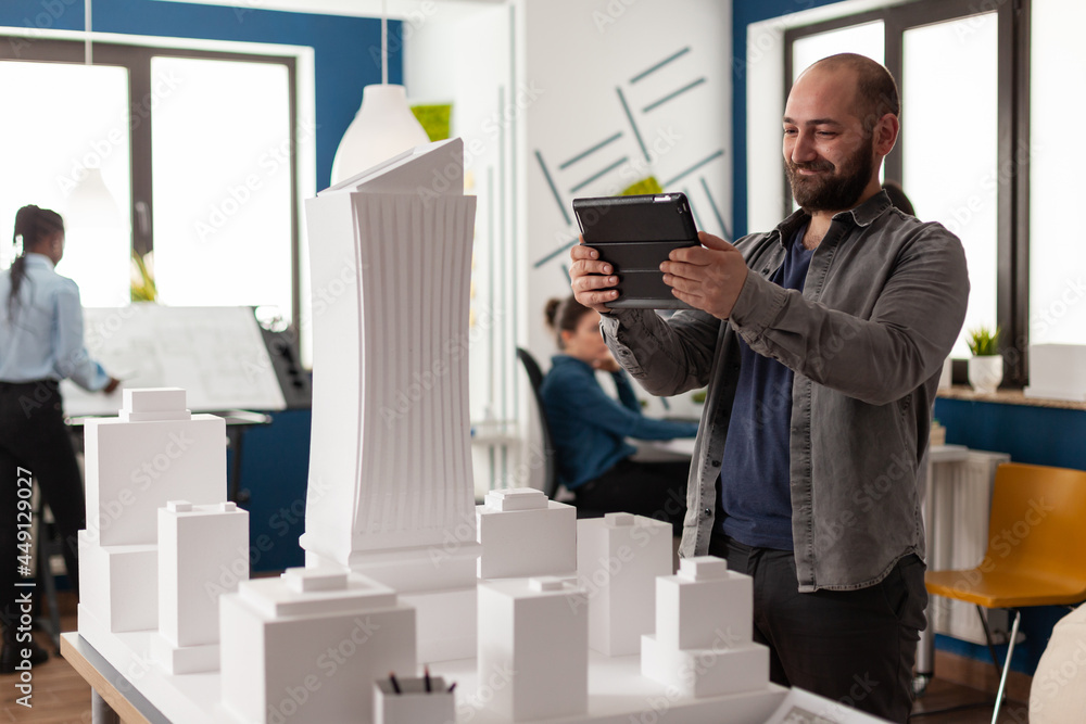Aufkleber work manager man looking on tablet at architecture office to design maquette construction layout bui
