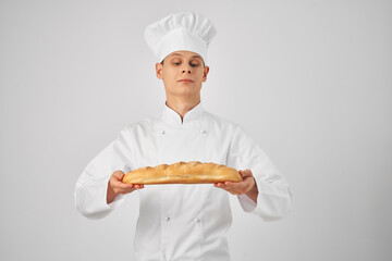 a man in chef's clothes Holding a loaf baker Professional
