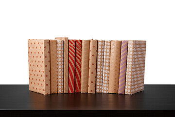 Stack of books on wooden table against white background