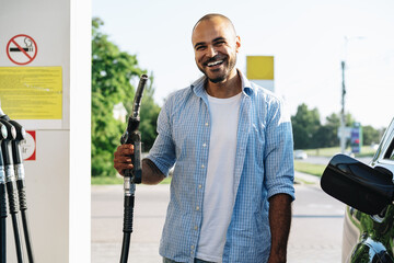 Man filling gasoline fuel in car at gas station