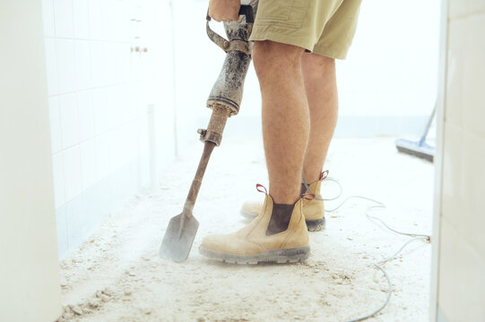 Workman jackhammering on construction site