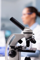 Selective focus on medical microscope standing on table in pharmacology microbiologist hospital...