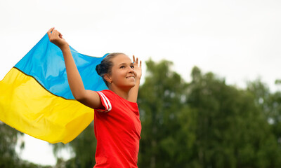 Happy ukrainian girl with wawing yellow and blue national flag Love Ukraine concept. Independence,...