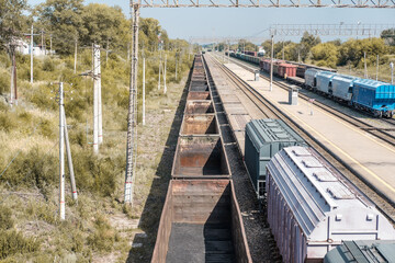 Railway freight cars on rails. Transportation of coal in freight wagons. View from above.