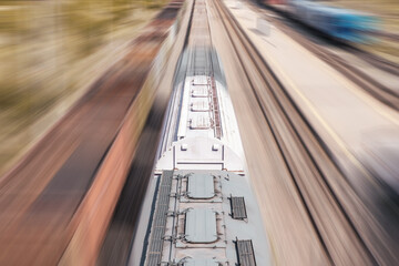 Freight train in motion at the station. Train with blur effect on the railway platform.