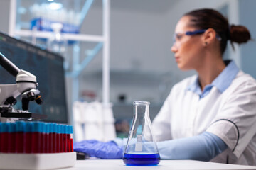 Fototapeta premium Scientist researcher woman typing pharmaceutical vaccine innovation results researching biochemistry experiment. Specialist doctor working at genetic dna infection in pharmacology hospital laboratory