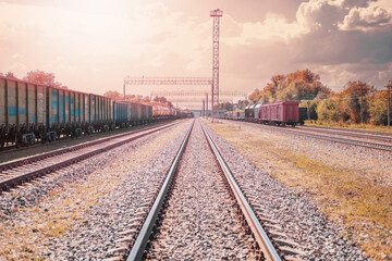 A railway line leading into the distance with a pleasant pastel sunset. Railroad tracks with...
