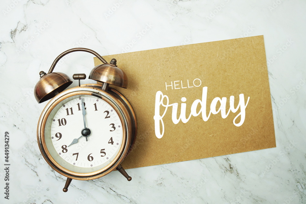 Poster hello friday typography text on paper card with alarm clock on marble background