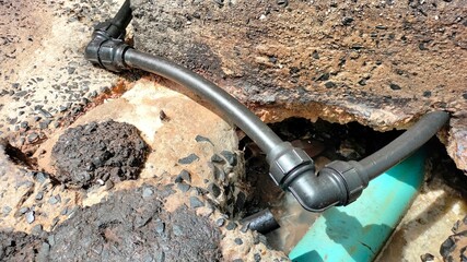 Elbows of plumbing pipes. PB elbow black 90 degree locking system on the water pipe to the house on...