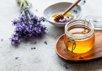 Jars with honey and fresh lavender flowers