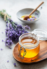 Jars with honey and fresh lavender flowers