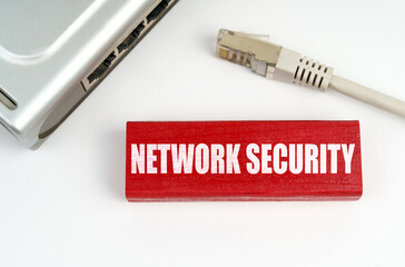 There is a router on the table, disconnected from the network, next to a plaque with the...