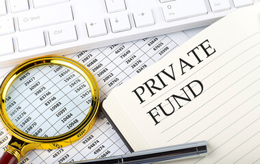 PRIVATE FUND text on the notebook with chart, magnifier,keyboard and pen