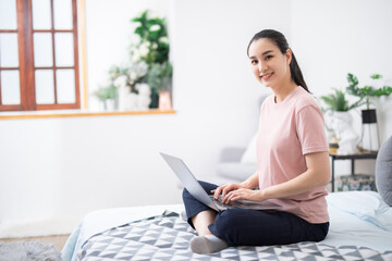 Beautiful asian girl using notebook in a desk at home,work from home concenpt.