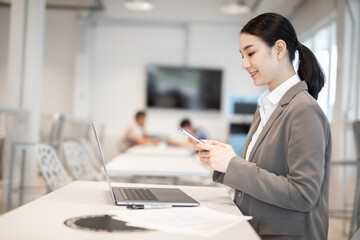 Asian woman celebrate with laptop, success happy pose. E-commerce, University education, internet Technology, or startup small business concept. Modern office or living room with copy space

