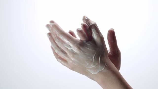 Cream rubbing on hands