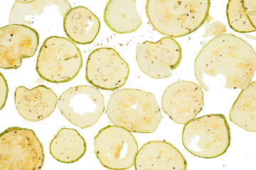 Dried slices zucchini or courgette with salt and spices over white background
