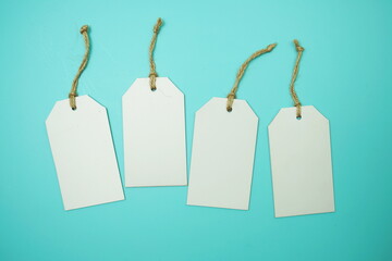 Flat lay White Blank Tag on blue background