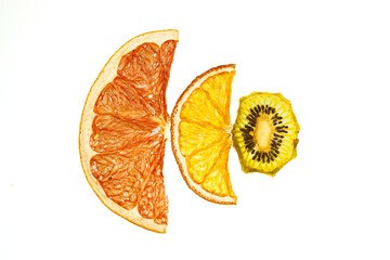 Dried fruit chips on a transparent white background Grapefruit, orange and kiwi. Tropical fruit set for bowls and dessert additions.