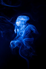 Fototapeta premium Motion blue smoke on black background.