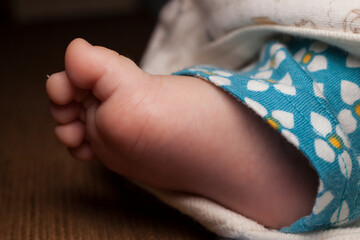 Tiny foot of newborn.