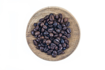 Coffee beans on wooden cutting board.