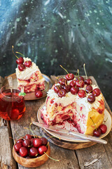 Cherry cake. Yeast bun with cherries and cream. A piece of cake. Top view, wooden and blue background.