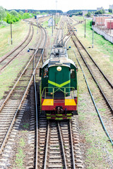 A shunting locomotive moves along the railroad from the station to sort the railroad cars. Railway tractor for joining wagons into a train.