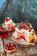 Cherry cake. Yeast bun with cherries and cream. A piece of cake. Top view, wooden and blue background.