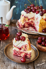 Cherry cake. Yeast bun with cherries and cream. A piece of cake. Top view, wooden and blue background.