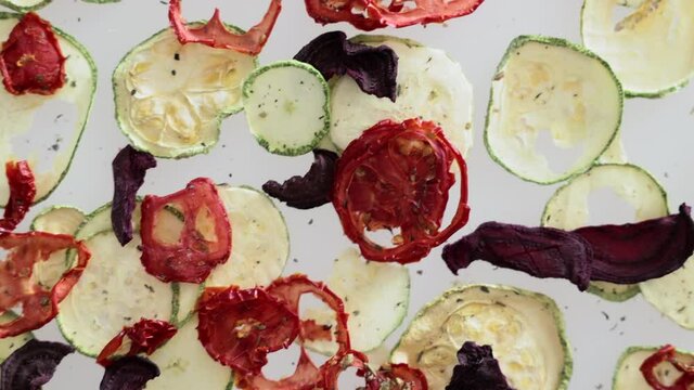 Dried beets, tomatoes with zucchini on an isolated white background. vegetable chips healthy snacks.