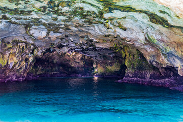 Polignano a Mare seen from the sea. Cliffs and caves