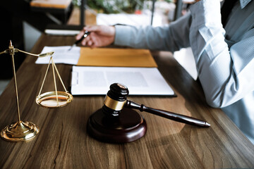 Legal counsel presents to the client a signed contract with gavel and legal law. justice and lawyer concept.