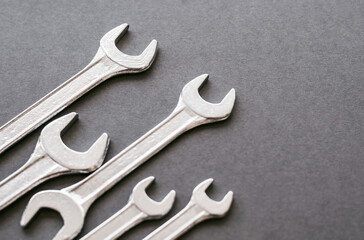 Set of wrenches in different sizes on grey background. Copy space