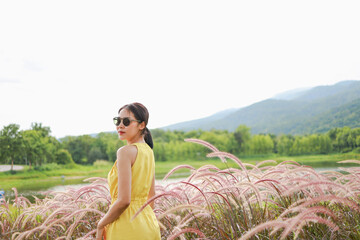 Summer Beautiful young woman fabulous nature waiting for summer sun on meadow vacation Asian girl Happy girl relaxing enjoys the autumn sunset