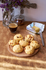 Cottage cheese buns with raisins. Wooden and white background. Side view.