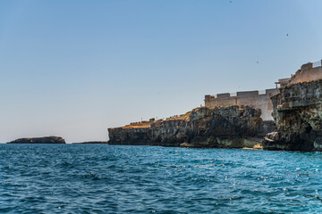 Fototapeta na wymiar Polignano a Mare seen from the sea. Cliffs and caves